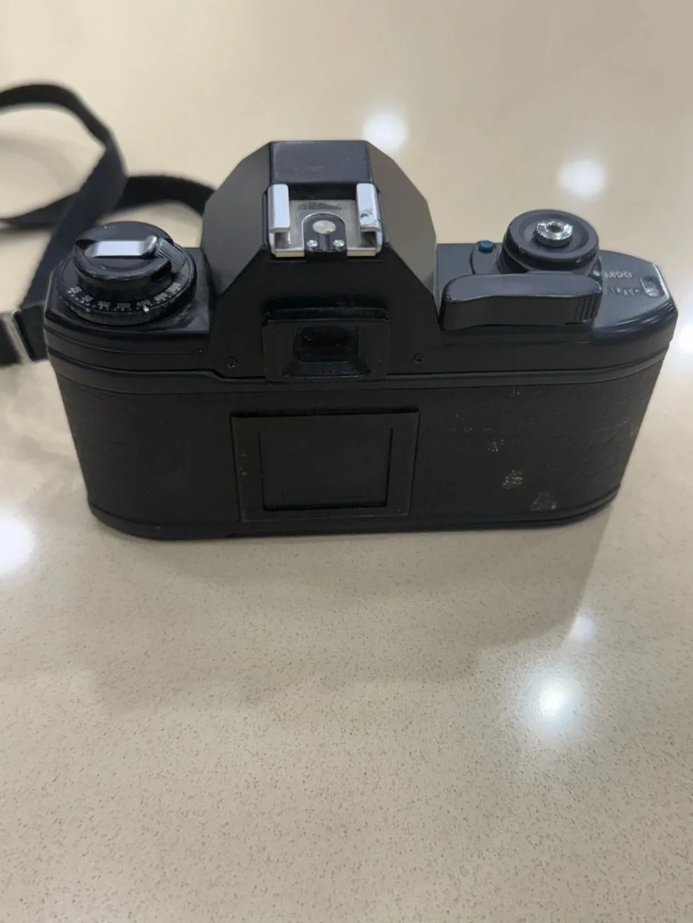 Nikon Black 35mm SLR Camera with Attached Lens and Strap
